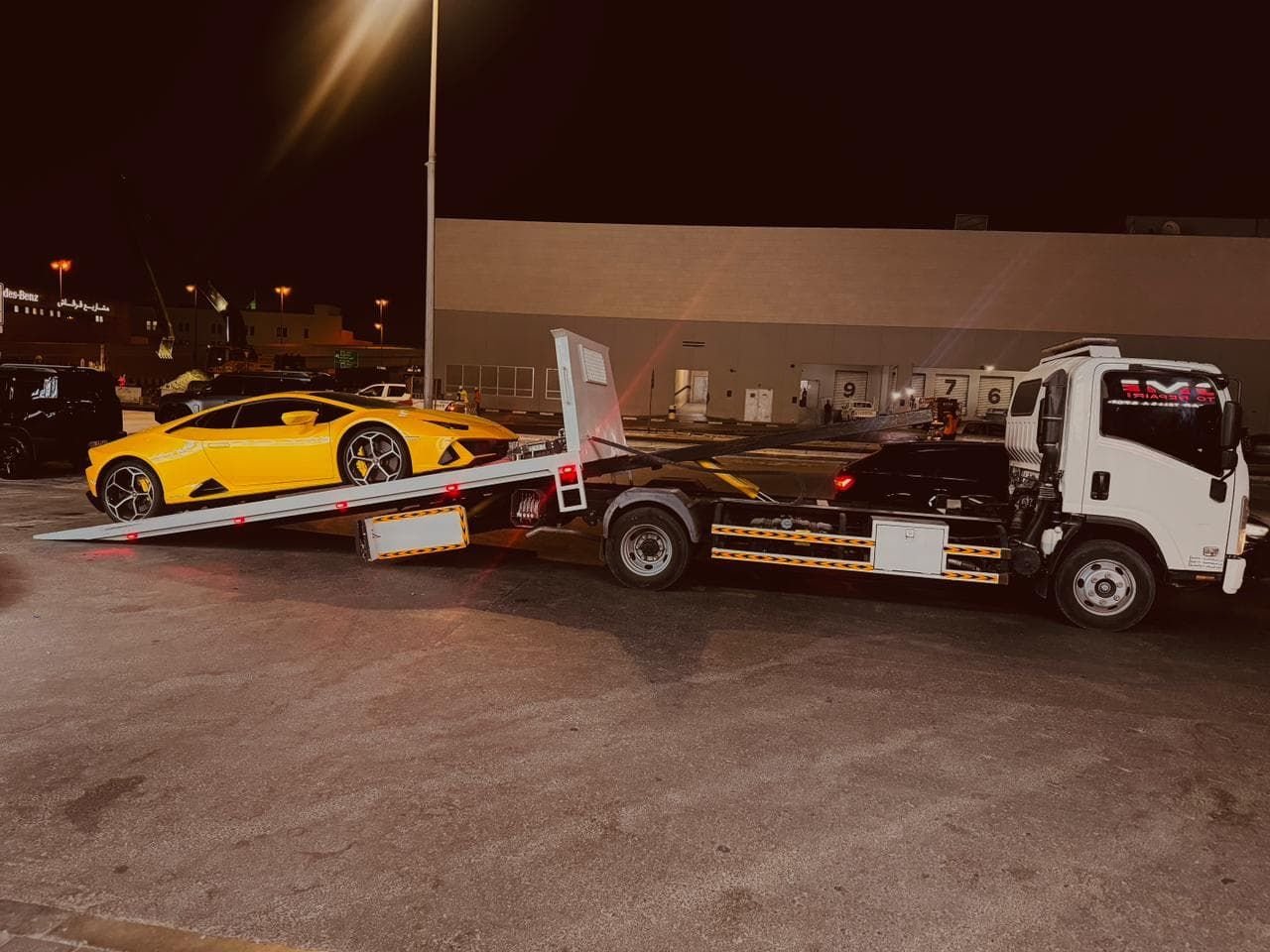 Yellow Lamborghini Huracan being recovered at night in Dubai