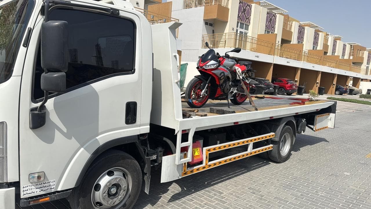Motorcycle strapped on a flatbed recovery truck in Dubai