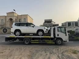 White Toyota Land Cruiser Prado on a flatbed tow truck